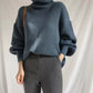 Dark blue ribbed knit oversized turtleneck sweater with voluminous sleeves