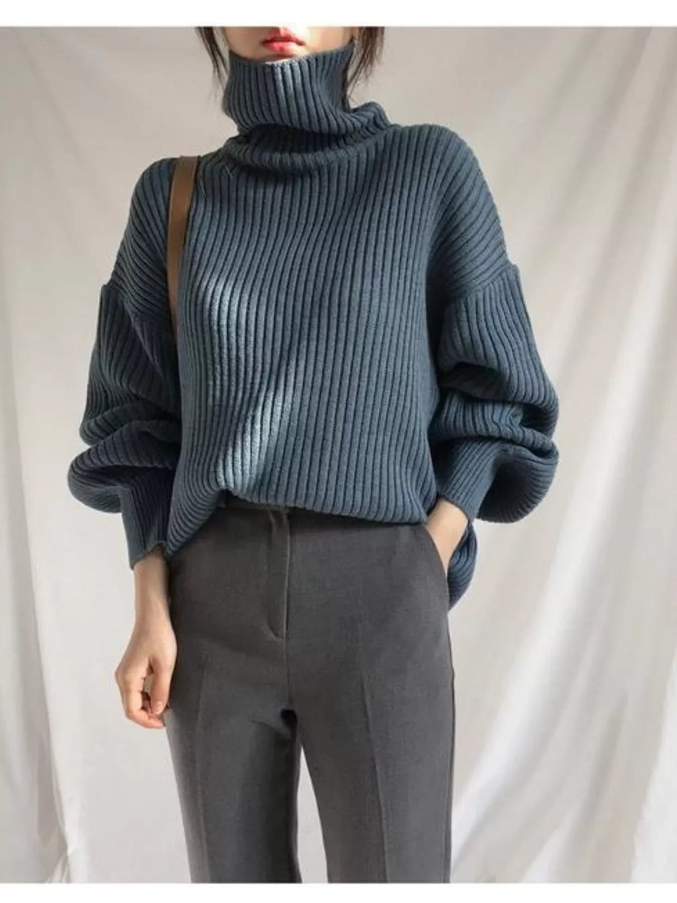 Dark blue ribbed knit oversized turtleneck sweater with voluminous sleeves