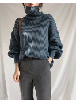 Dark blue ribbed knit oversized turtleneck sweater with voluminous sleeves