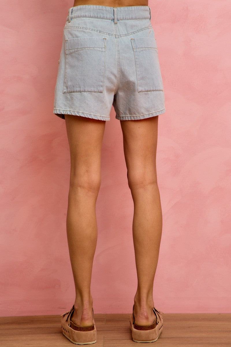 Back view of SO ME mid-rise denim shorts with frayed hem and back pockets