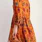 Bohemian floral print long sleeve mini dress in vibrant orange with purple pink blue yellow patterns