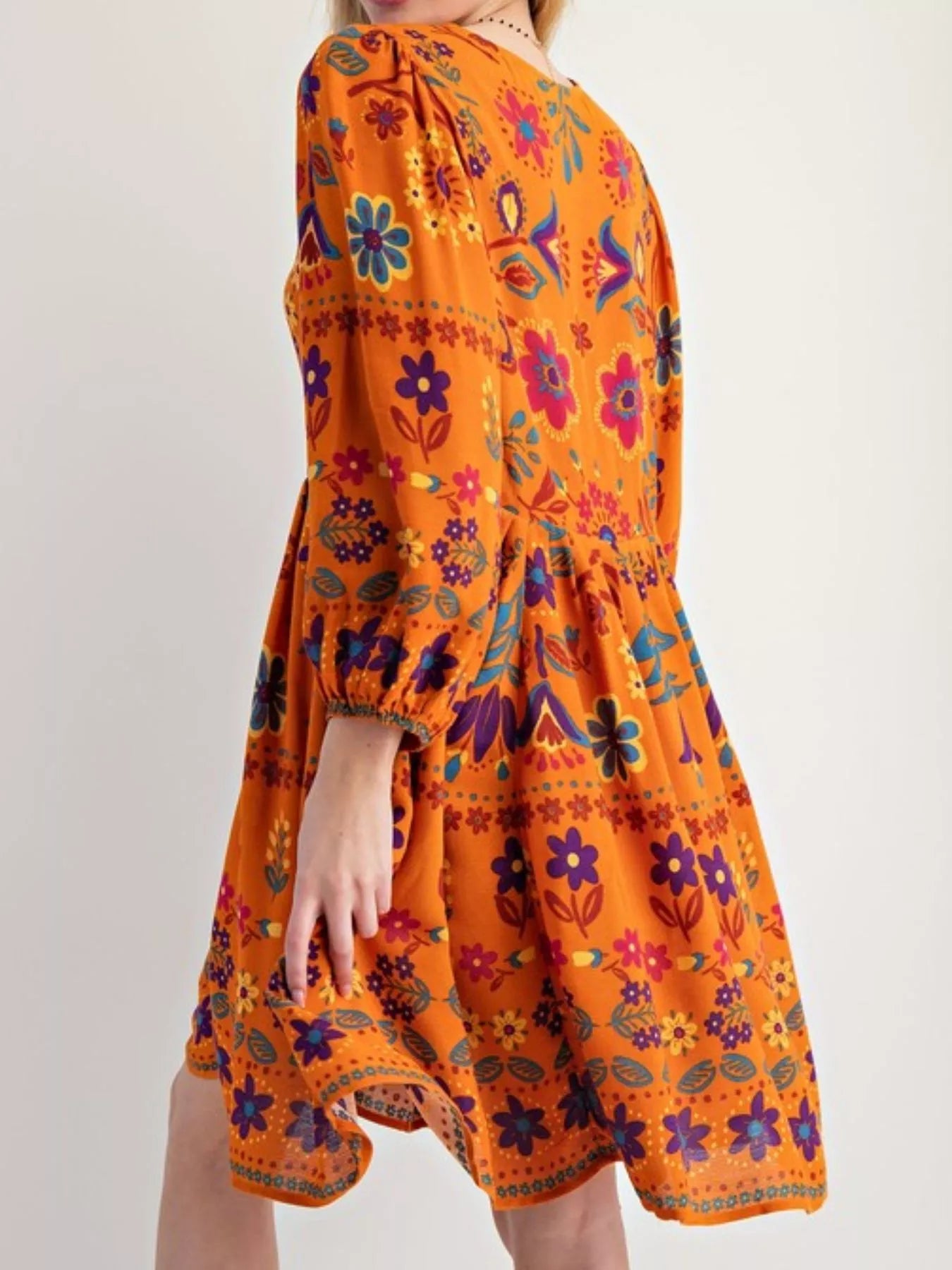 Bohemian floral print long sleeve mini dress in vibrant orange with purple pink blue yellow patterns