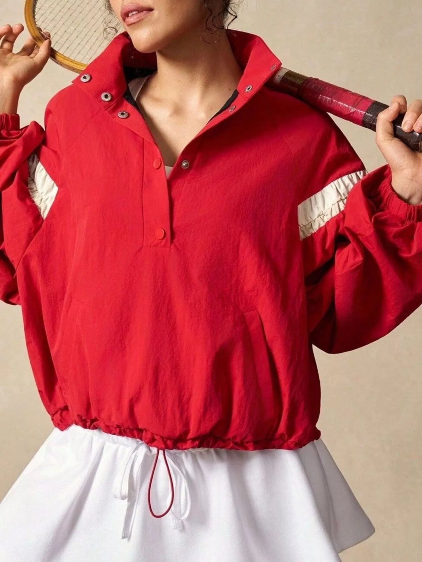 Red athletic jacket with white accents, silver snaps, half snap drawstring hem