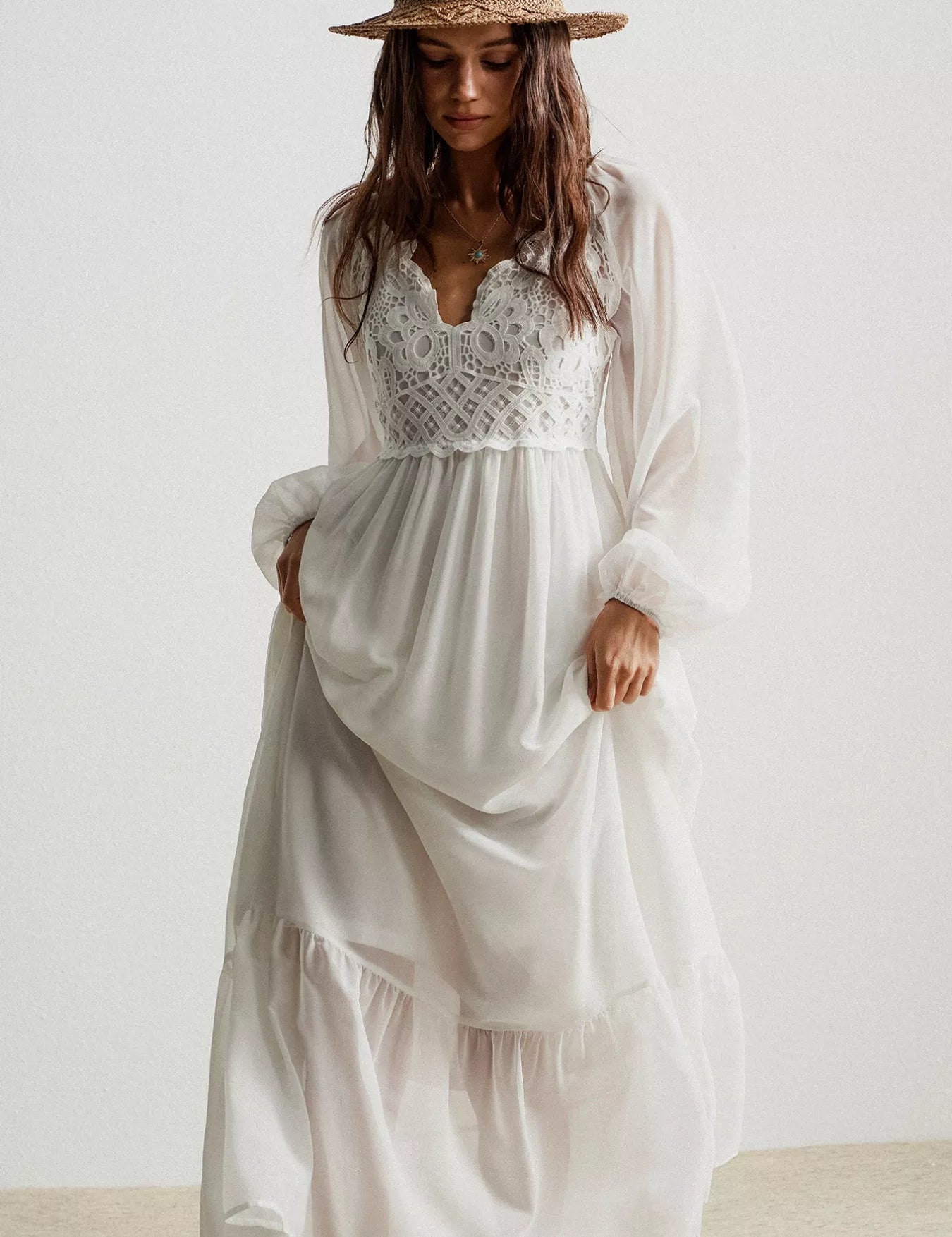 White bohemian crochet lace maxi dress with long sleeves and layered skirt