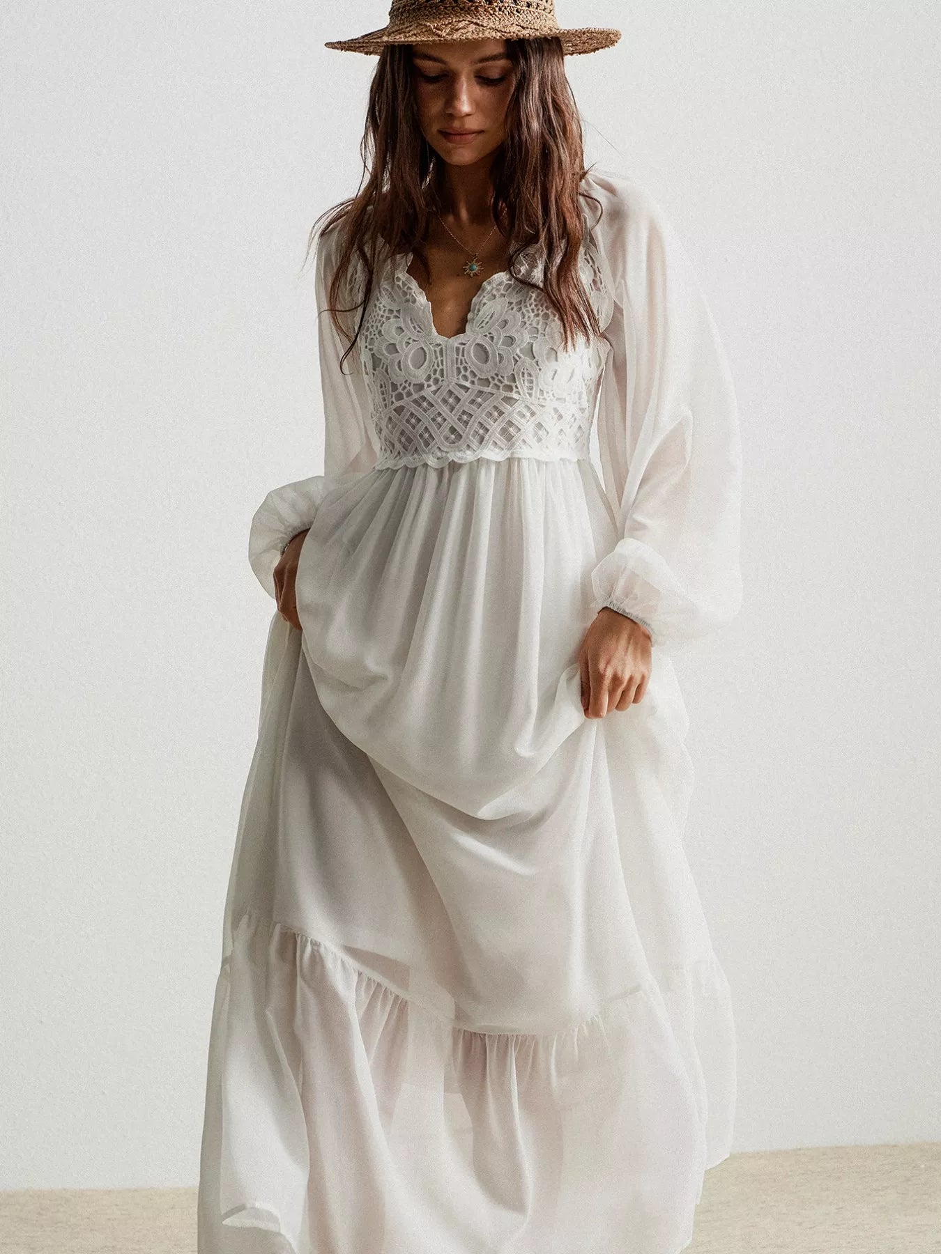 White bohemian crochet lace maxi dress with long sleeves and layered skirt