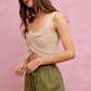 Beige textured knit crop top with cutout detail over SO ME twill shorts