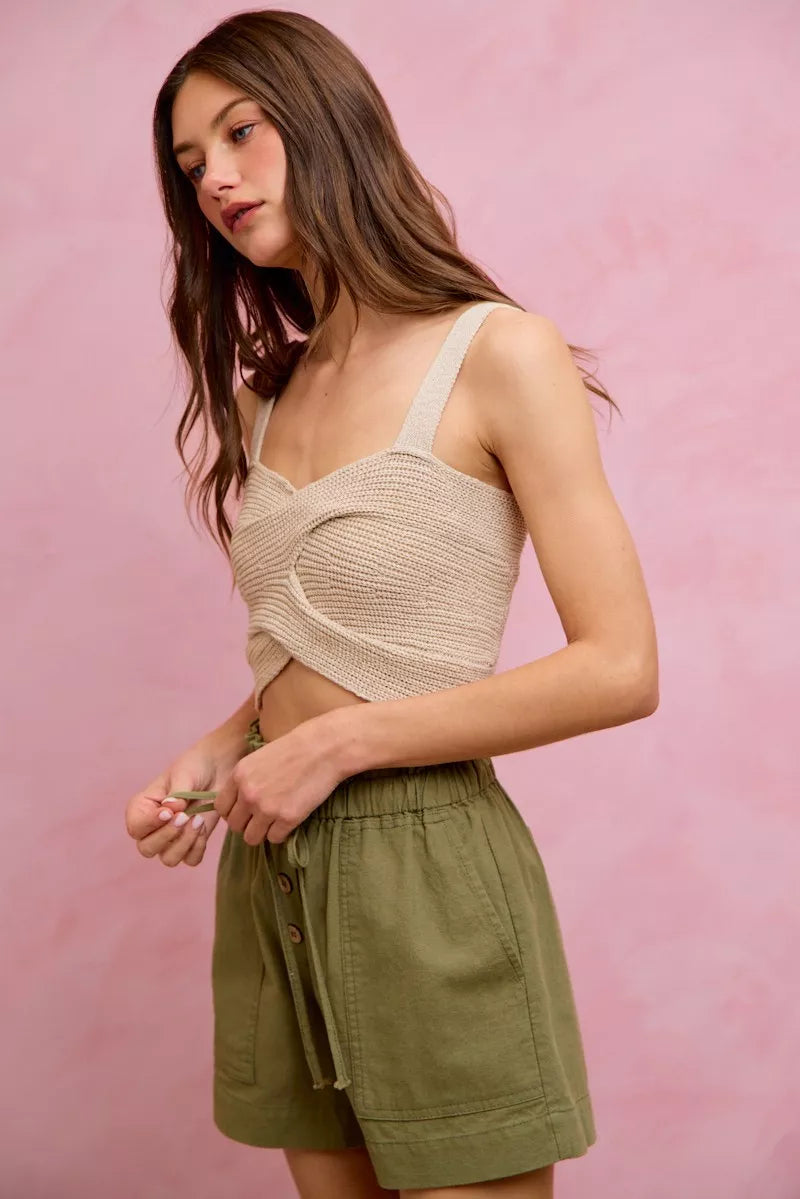 Beige textured knit crop top with cutout detail over SO ME twill shorts
