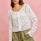 White crochet cardigan with lace patterns on SO ME twill shorts