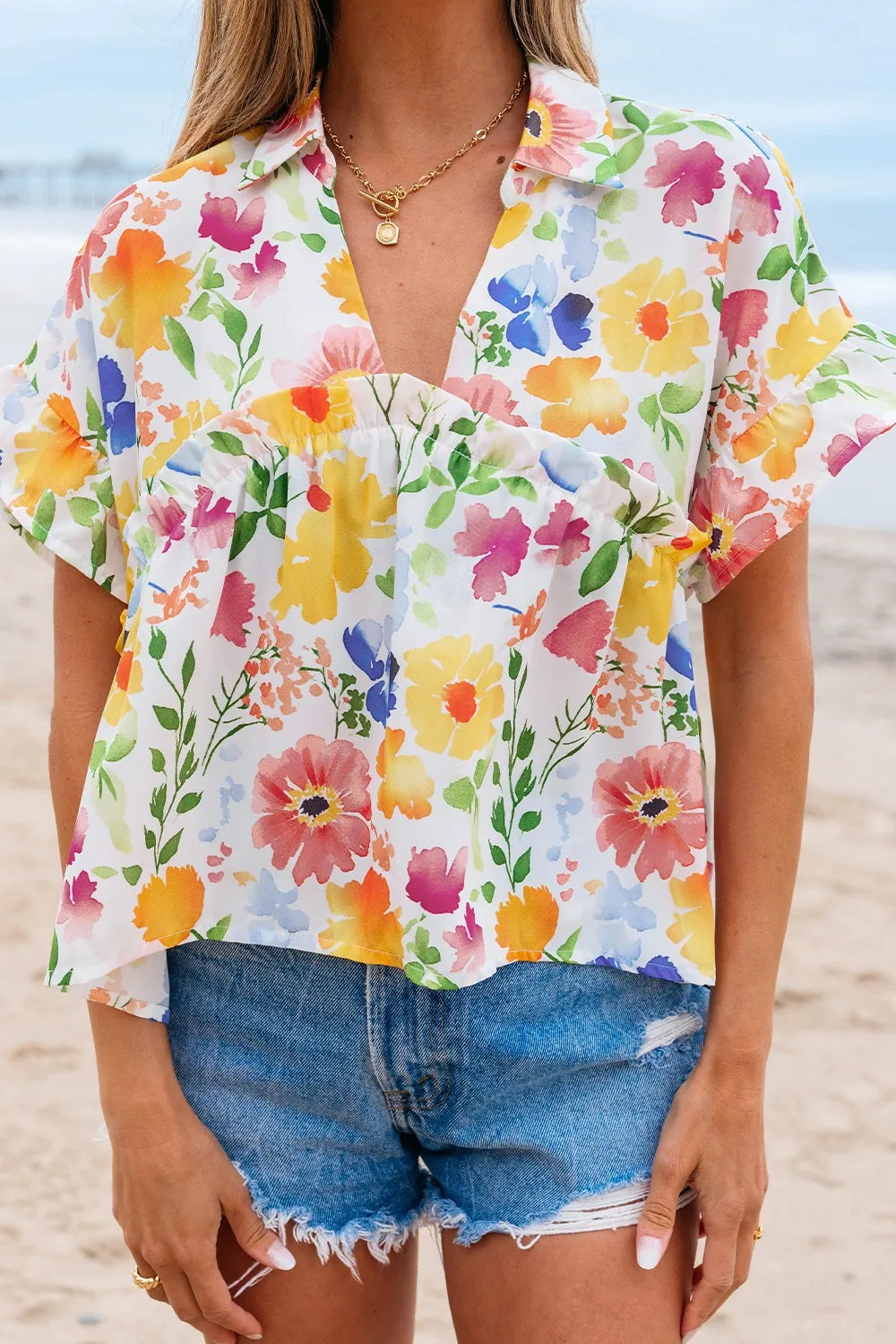 Floral boxy fit ruffled short sleeve blouse with vibrant blossoms
