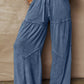 Tiered wide-leg washed pants in blue denim with drawstring waist and patchwork