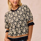 BiBi Textured Rose Knit Top with black and cream floral print and ruffled sleeves