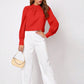 Vibrant red ruched mock neck long-sleeve blouse with puffed sleeves
