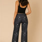 Womens low rise rhinestone jeans with starry night denim print and rolled cuffs