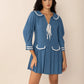 Blue pleated mini dress with Peter Pan collar and white trim