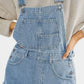 Light-wash denim overalls with square neck, wide straps and pockets