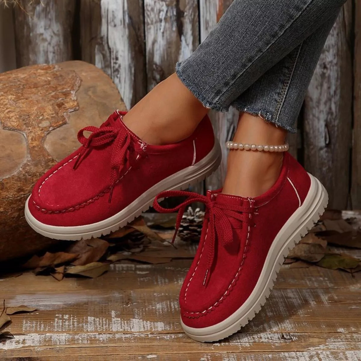 Red suede lace-up round toe loafer with white sole and pearl anklet