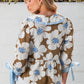 Brown floral print blouse with ruffled collar, striped tie cuffs