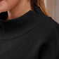Black ribbed mock neck top in dropped shoulder sweatshirt