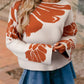 Boho flower pattern oversized knit sweater in cream with rust-orange florals and bell sleeves