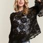 ADORA Bell Sleeve Crochet Top with black floral patterns and sheer sleeves