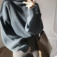 Cozy dark gray ribbed knit oversized turtleneck sweater with voluminous sleeves