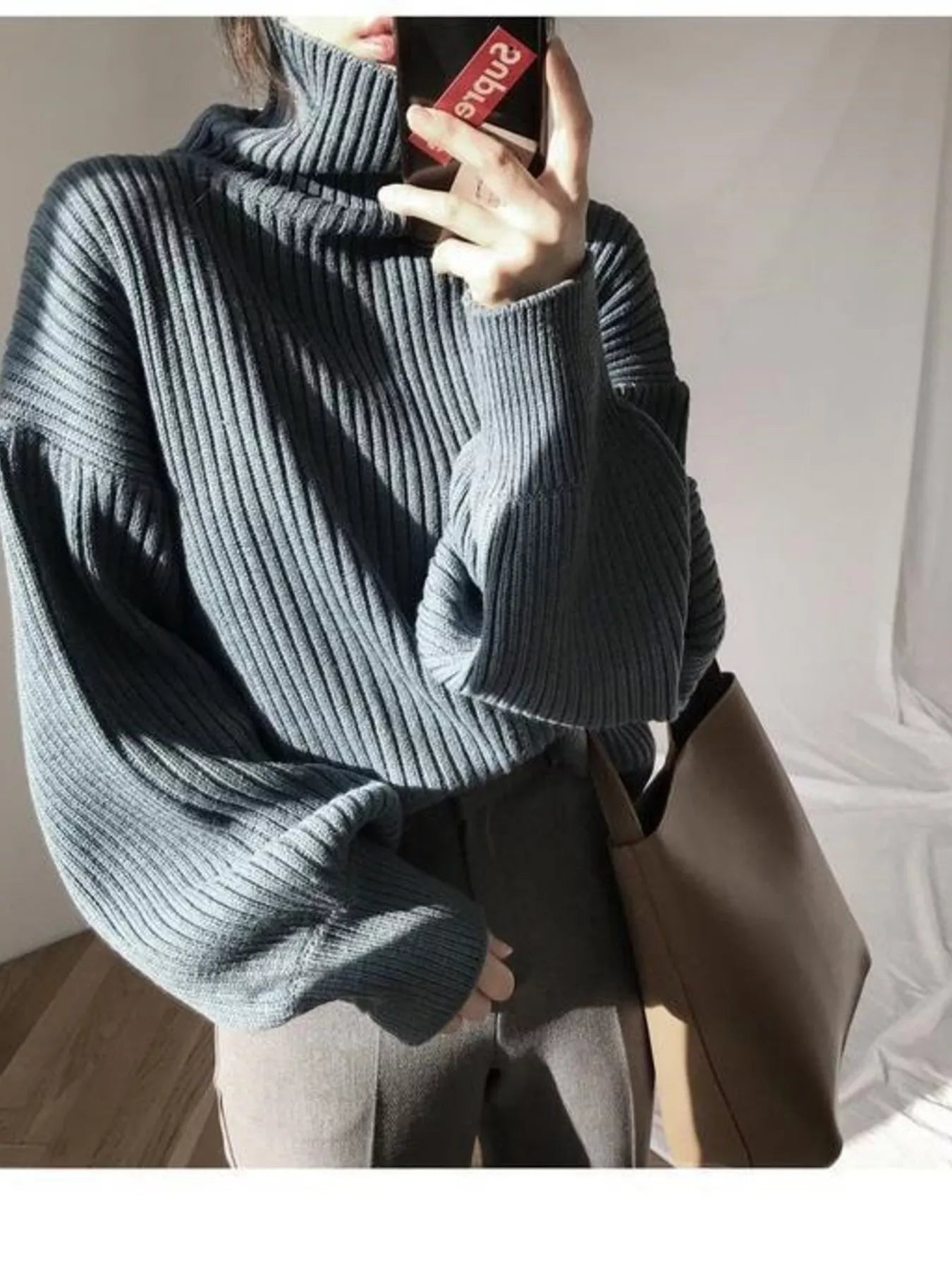 Cozy dark gray ribbed knit oversized turtleneck sweater with voluminous sleeves