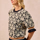 Black and cream floral BiBi Textured Rose Knit Top with ruffled sleeves