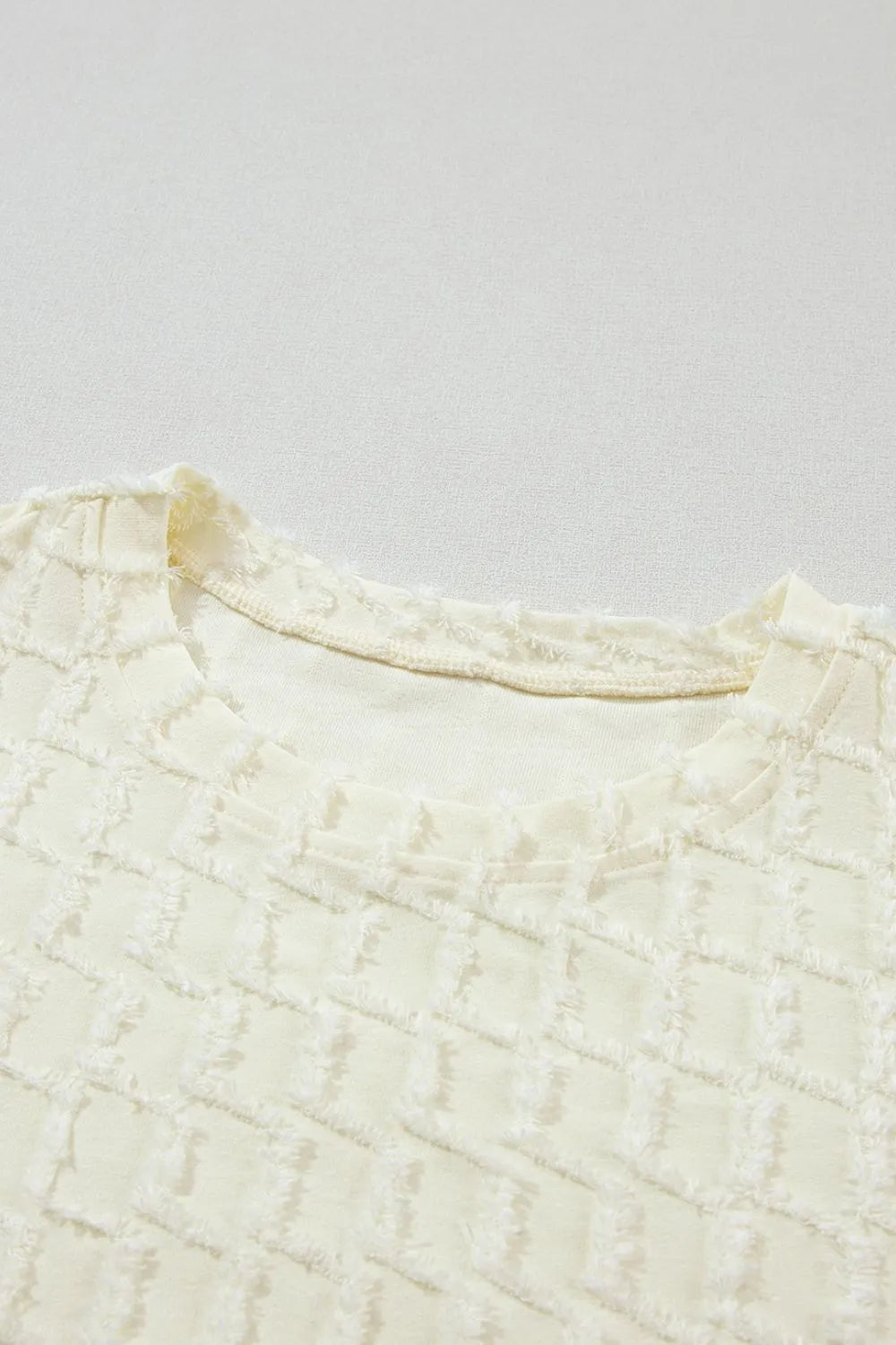 Daverri textured round neck knit top, cream with ruffled neckline