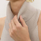 Backless turtleneck sweater tank in taupe ribbed knit with high folded collar