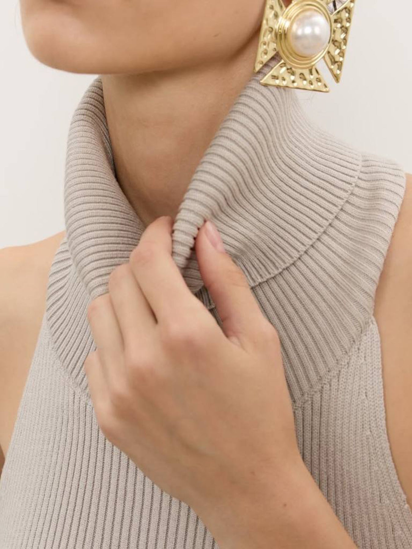 Backless turtleneck sweater tank in taupe ribbed knit with high folded collar