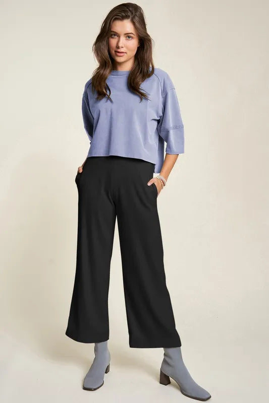 Woman in lavender top and Davi & Dani wide-leg pants