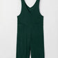 Dark green sleeveless corduroy jumpsuit with V-neck and patched pockets