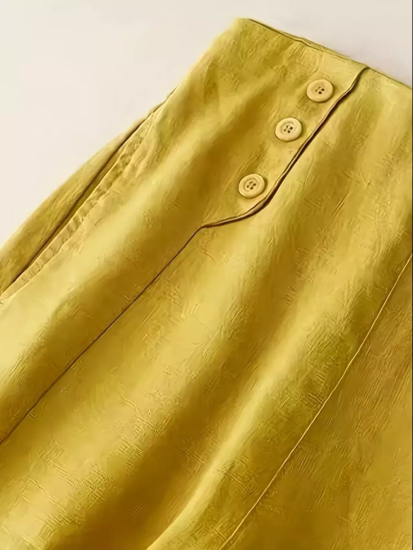 Daverri wide-leg pants back view in mustard-yellow satin with button waistband