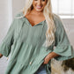 Soft sage green loose-fitting V-neck blouse with ruffled sleeves