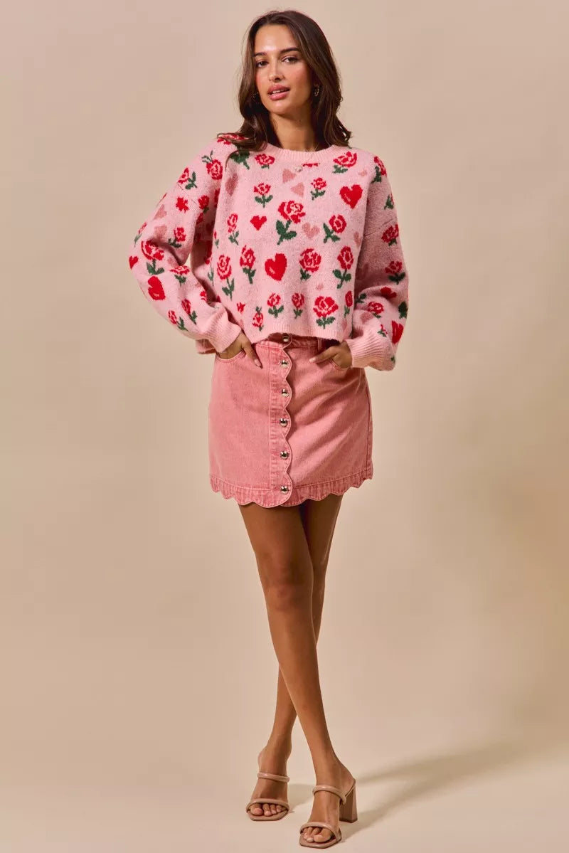 Pink sweater with red roses, hearts, and scalloped hem over SO ME denim mini skirt