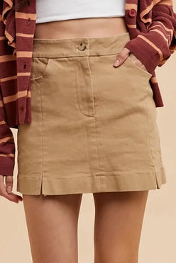 Khaki high-waisted mini skirt with front pockets, pleats, and slit details