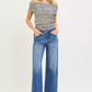 Woman in off-shoulder striped top and RISEN high-rise relaxed fit ankle straight cuff jeans
