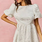 White floral jacquard SO ME mini dress with puffed short sleeves and fitted waist
