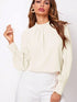 Cream-colored ruched mock neck long sleeve blouse with pleated collar