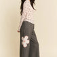 Gray wide-leg pants with pink floral thigh patch and Davi & Dani top