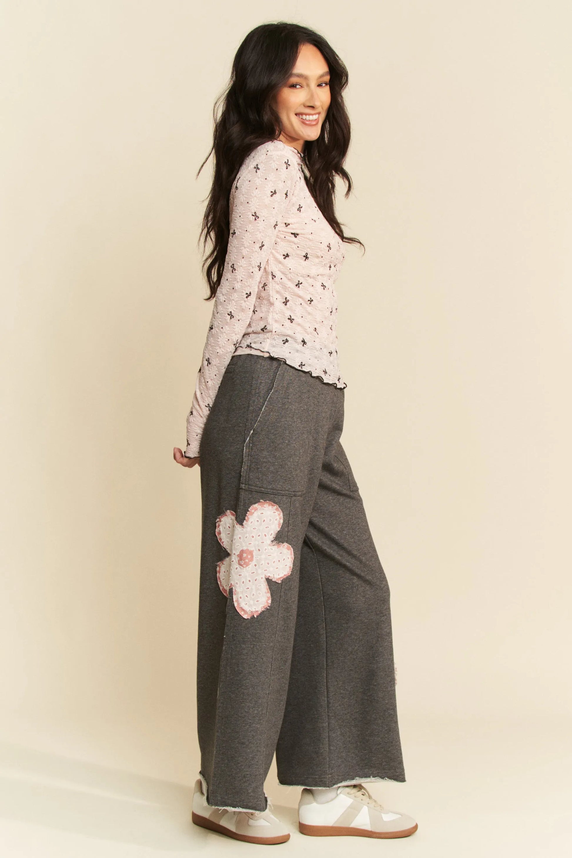 Gray wide-leg pants with pink floral thigh patch and Davi & Dani top