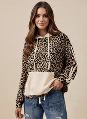 Leopard print long sleeve hoodie with white accents, drawstring hood, and pocket