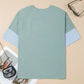 Oversized mint green t-shirt with frayed denim star patches and blue sleeve panels