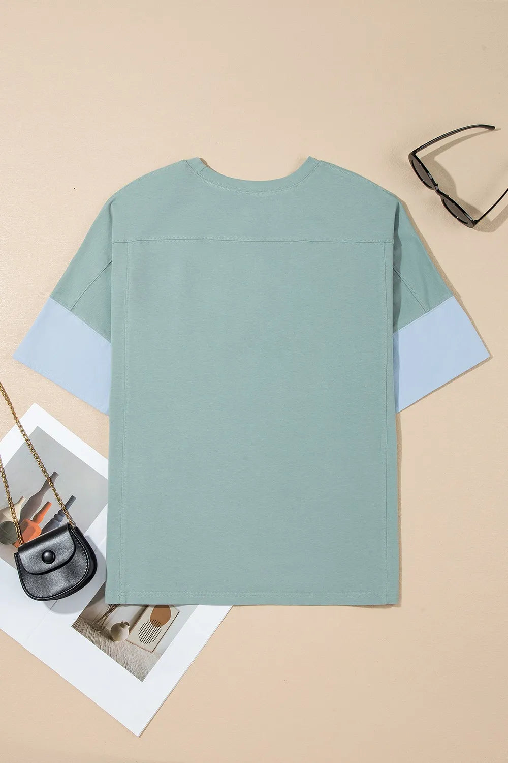 Oversized mint green t-shirt with frayed denim star patches and blue sleeve panels