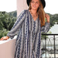 Woman in plus size boho print V-neck long sleeve mini dress