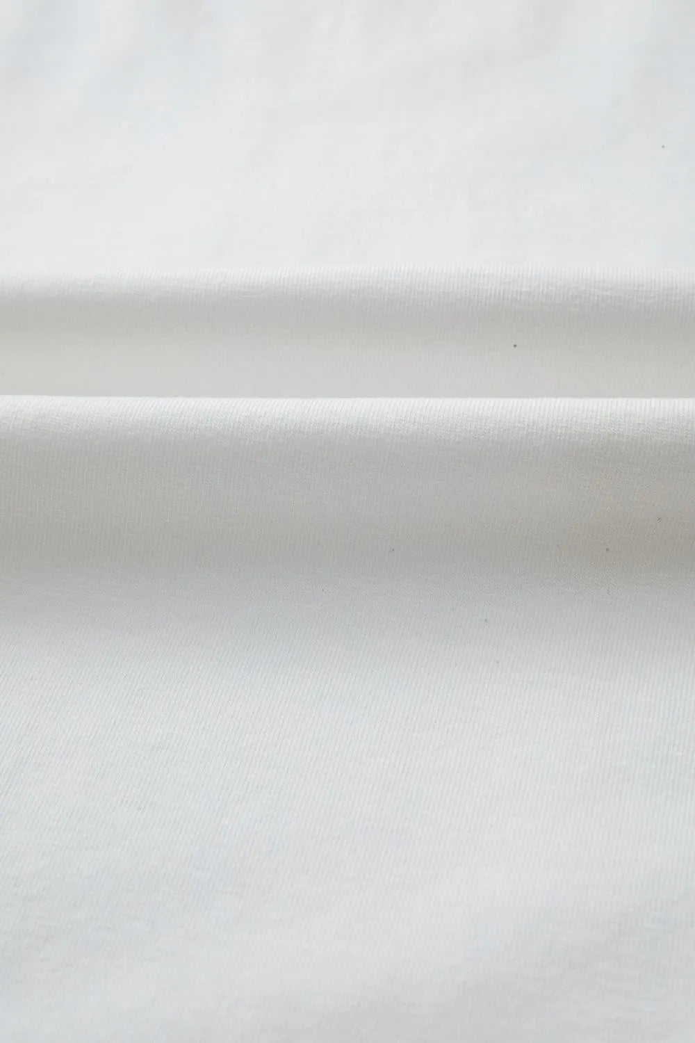 White smooth-textured fabric in Star Layered Patched Graphic Tee