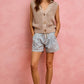 Beige knitted sleeveless cardigan with buttons over SO ME denim shorts