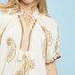 Umgee Paisley embroidered cream top with gold details and ruffled sleeves
