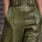 Olive green high-waisted faux leather wide flare pants with silver buckles