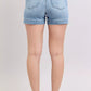 Back view of Judy Blue mid-rise light-wash denim shorts with leather patch